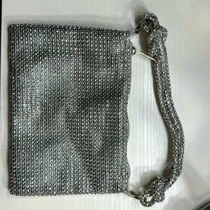 Thick mesh, bedazzled bag. Used once for a wedding. Perfect condition.